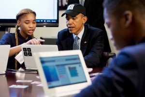 ADDS NAME - President Barack Obama is explained a coding learning program by Adrianna Mitchell during an “Hour of Code” event in the Eisenhower Executive Office Building on the White House complex in Washington, Monday, Dec. 8, 2014, attended by middle-school students from Newark, N.J. (AP Photo/Jacquelyn Martin)